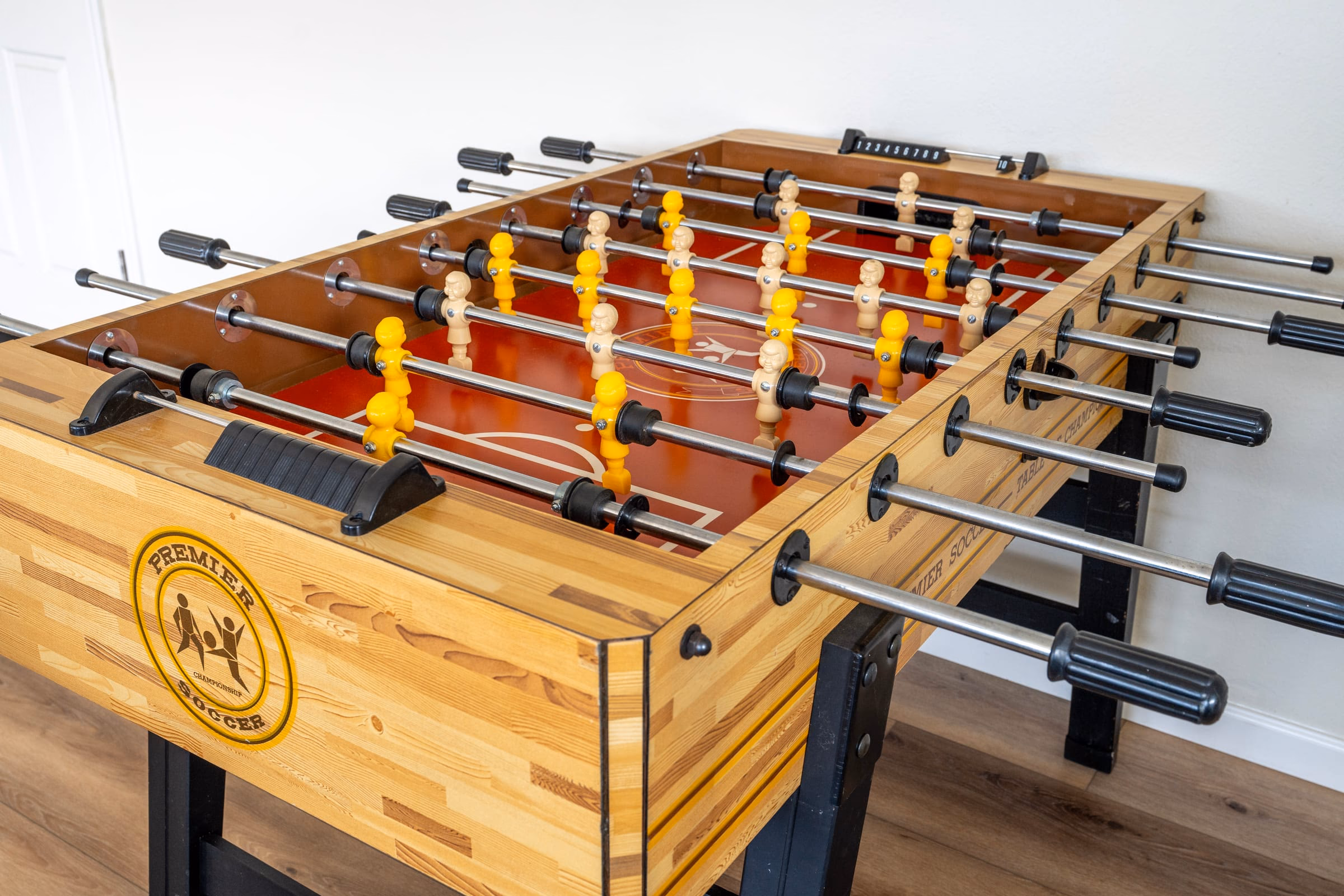 Full-size wooden foosball table in the indoor recreation area