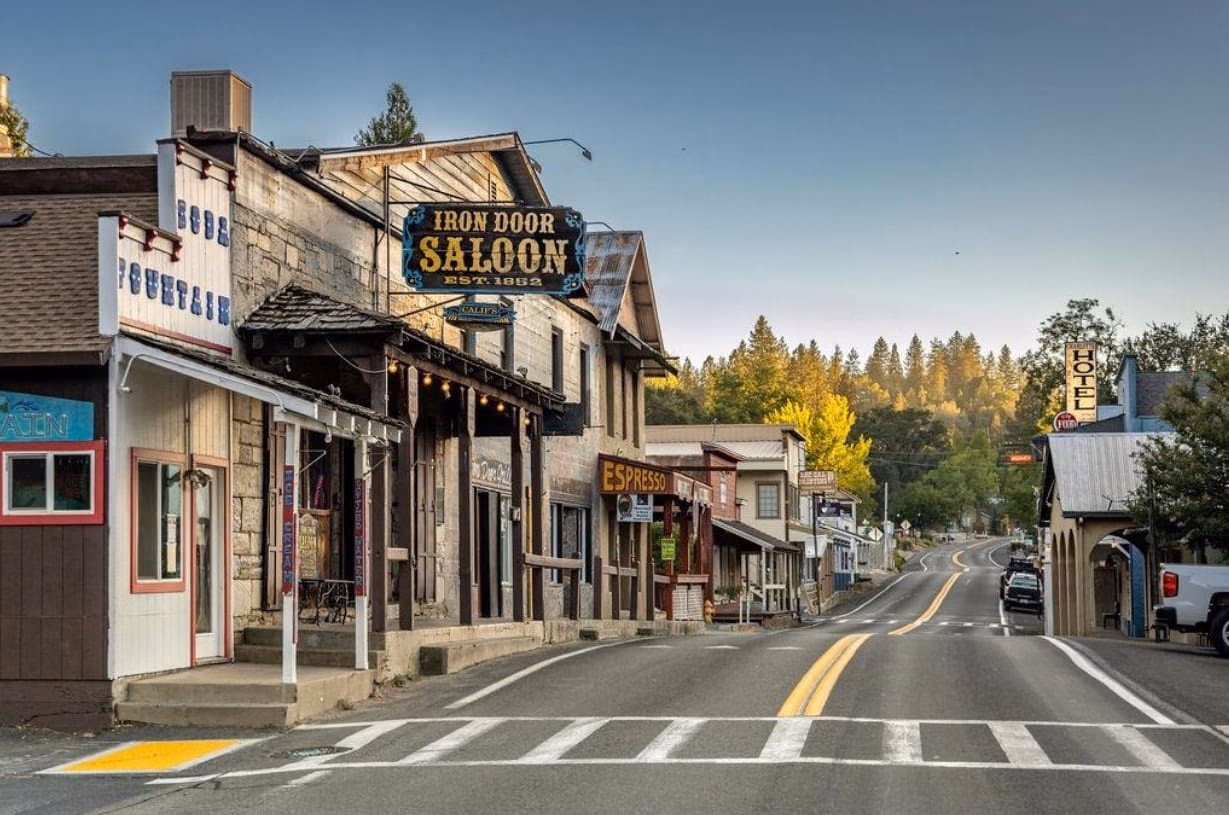 Historic storefronts and the Iron Door Saloon along the main road through downtown Groveland