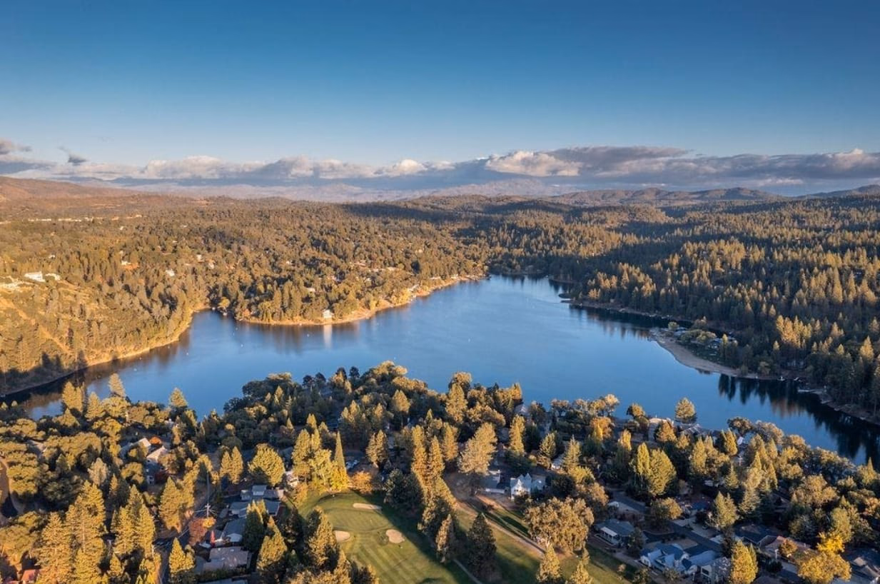 Aerial view of Pine Mountain Lake surrounded by forested hills, homes and part of the golf course